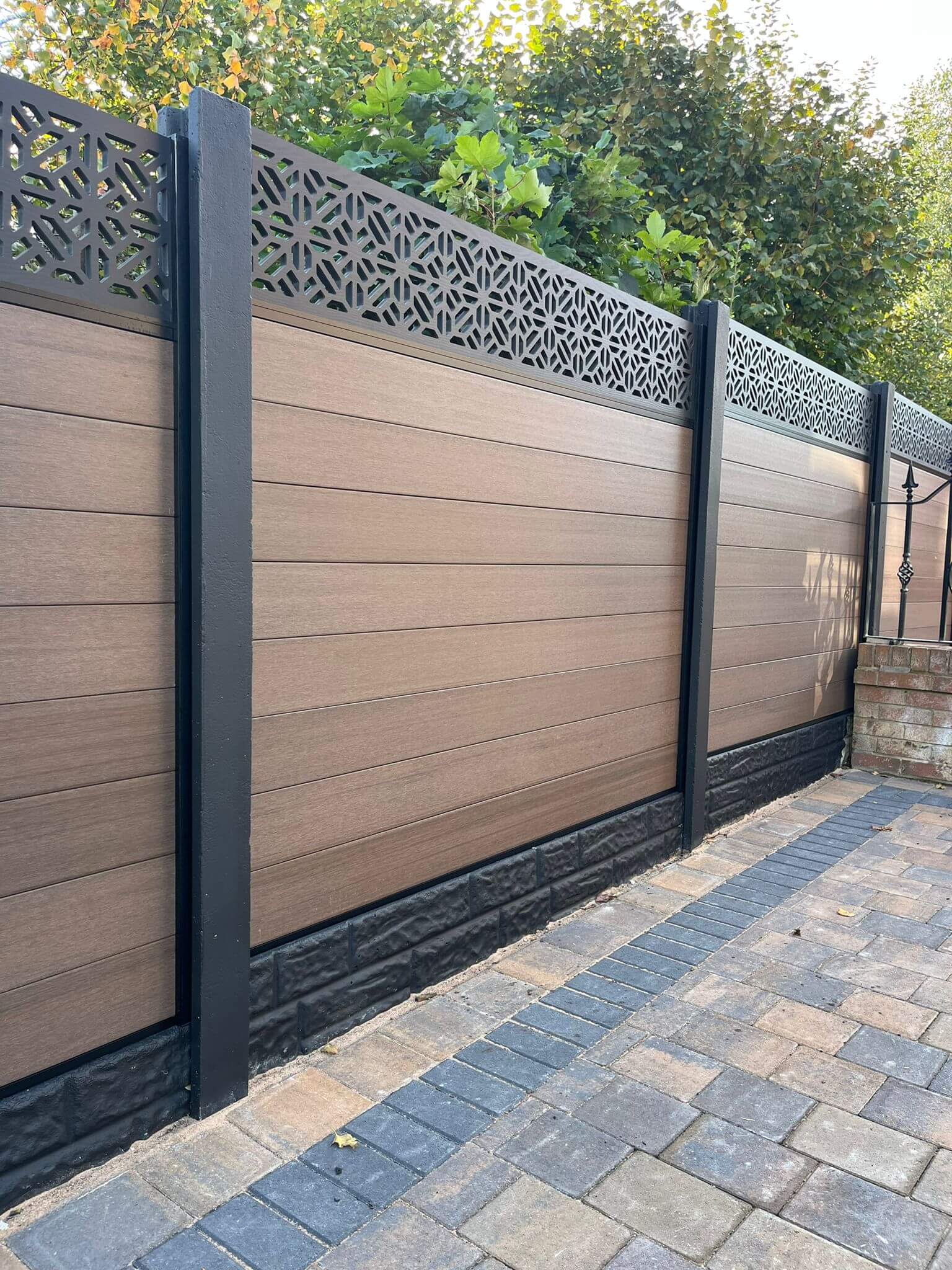 composite fencing in walnut installed with concrete posts