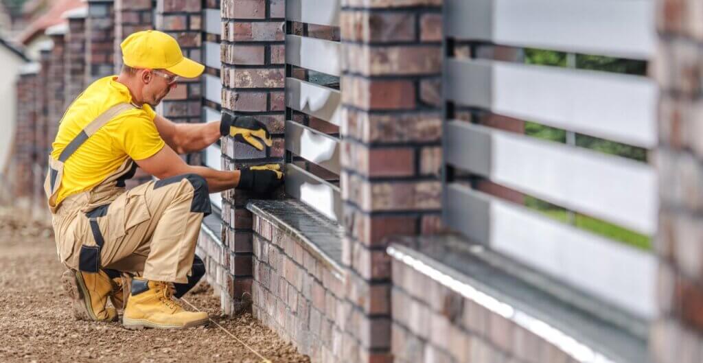 man fixing and maintaining aluminum fence