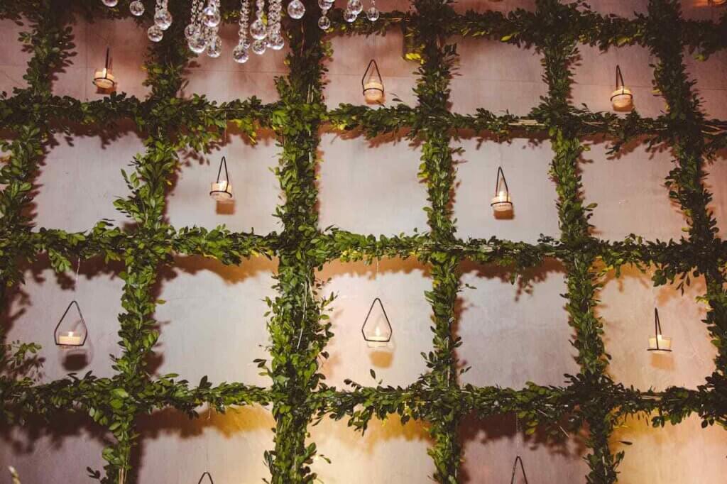 Candles Hanging on Trellis mounted to a wall