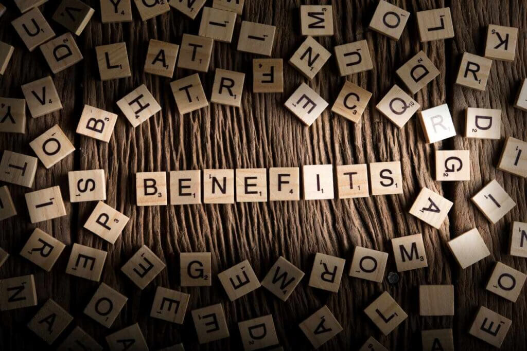 the word benefits spelled out on wooden tiles