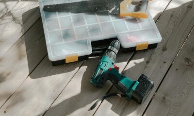 drill and saw lying on a wooden deck