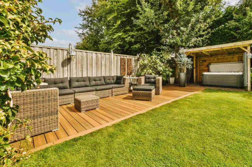 A backyard with wooden decking and furniture