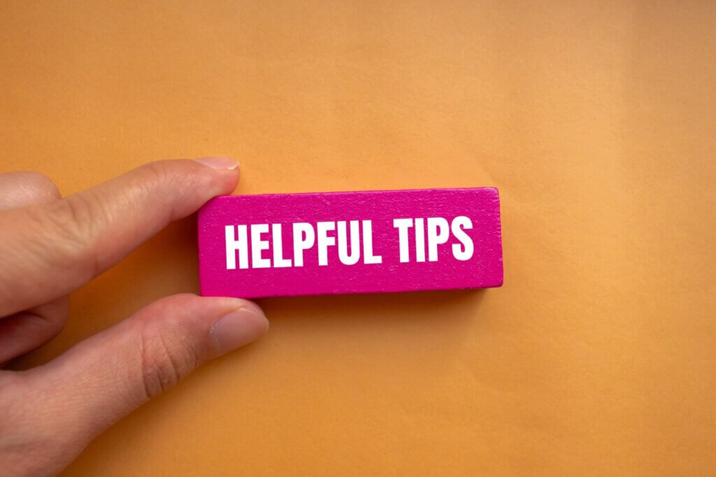 
Helpful tips message written on pink wooden block