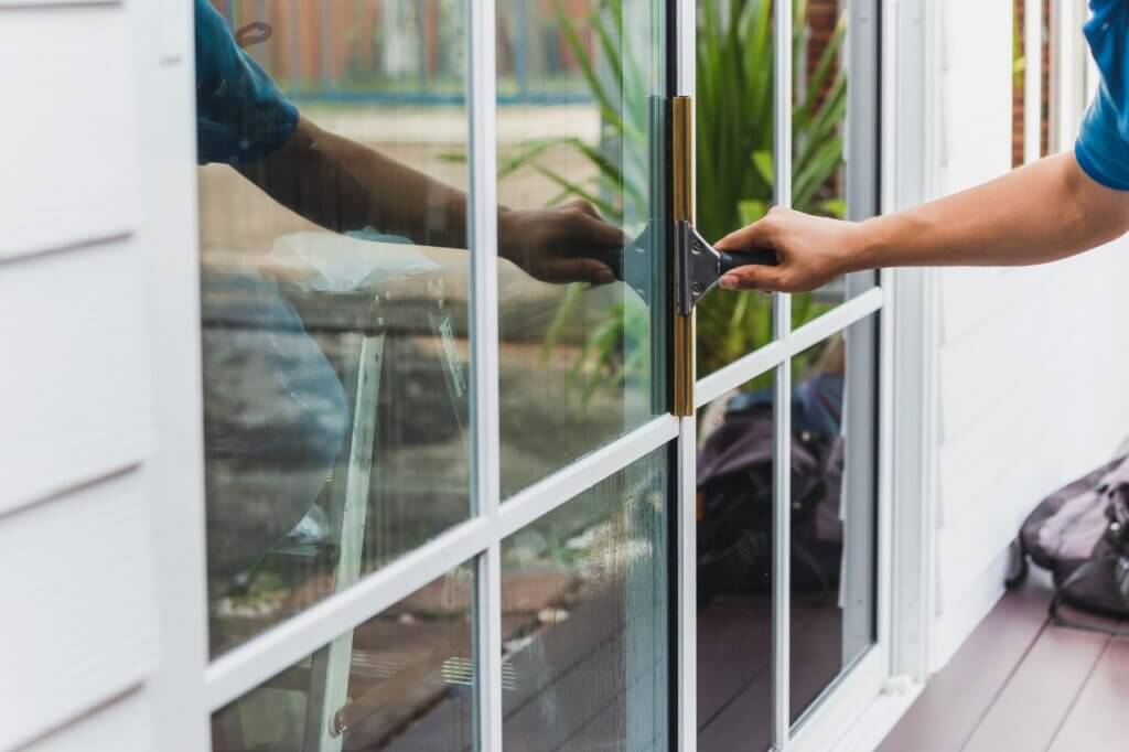 person cleaning a window